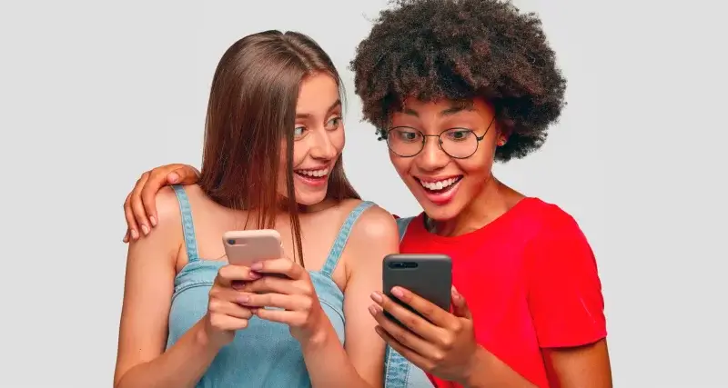 Duas amigas repercutindo buzz marketing com celular na mão